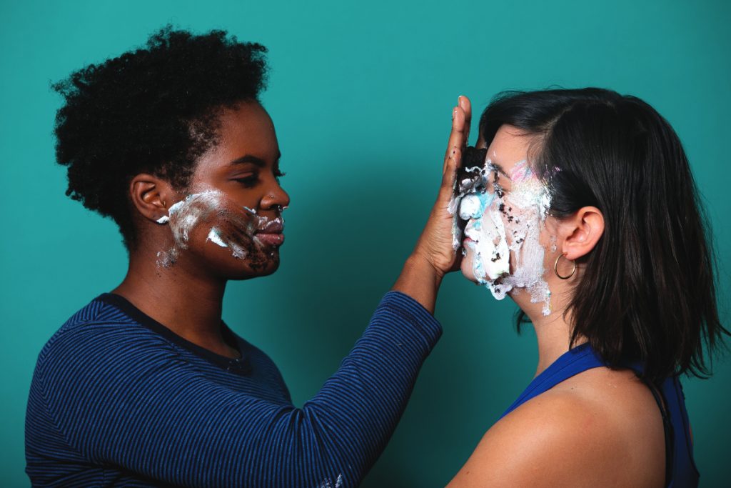 D.C. Dance Companies: A darlingdance performer smears icing on another's face.