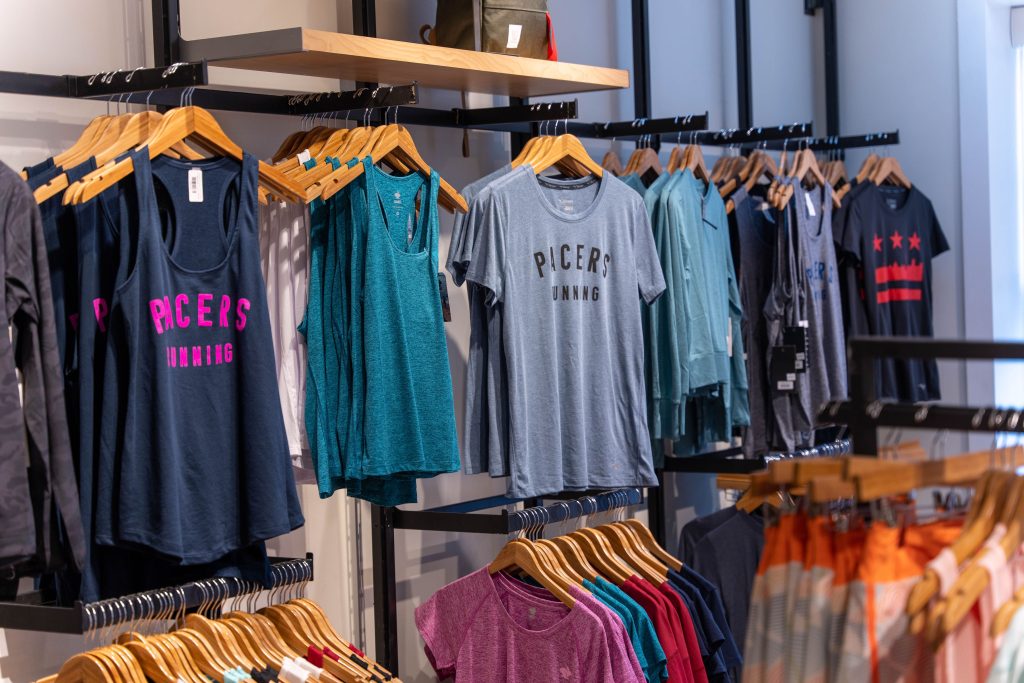 Racks of shirts that say "Pacers Running"